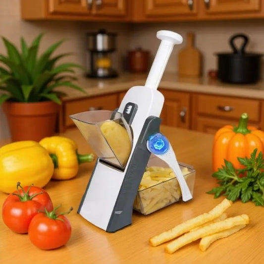 Vegetable peeler on a kitchen counter with vegetables and a pumpkin.